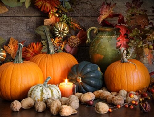 Decorative gourds, leaves, berries, and a candle