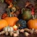 Decorative gourds, leaves, berries, and a candle
